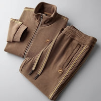 Folded brown corduroy jacket and pants set on a gray background